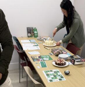 TNEI colleagues plating up cake in Manchester during Macmillan Coffee Morning 2026